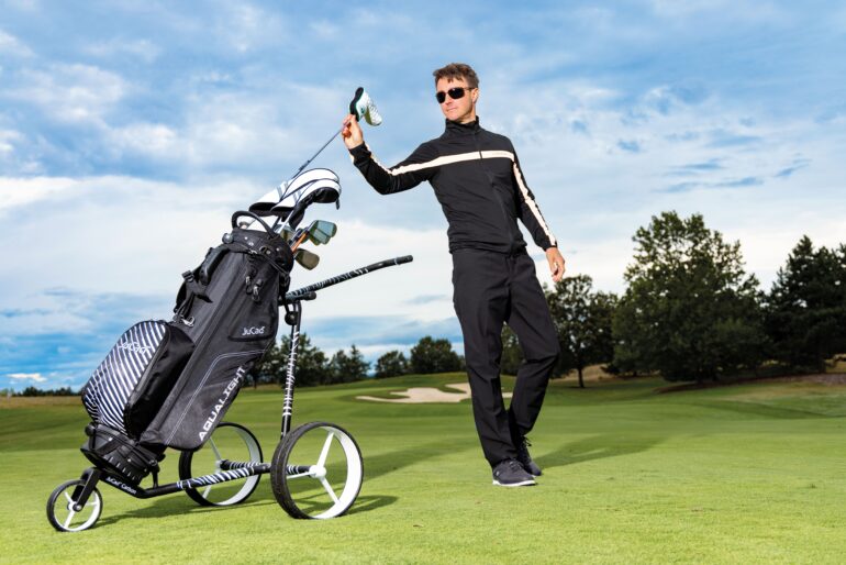 JuCad Trolley in Schwarz mit Golfbag auf dem Golfplatz